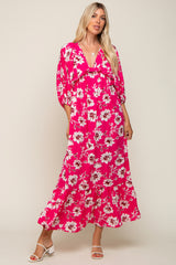 woman wearing a vibrant pink floral maxi dress with puff sleeves and a ruffled hemline