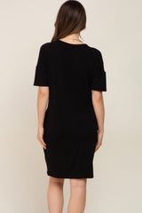 back view of a woman wearing a short sleeve black t-shirt dress