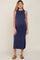 pregnant woman wearing a navy blue sleeveless maternity midi dress with side slits and brown sandals