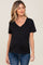 Woman wearing a black v-neck maternity t-shirt with a front pocket and blue jeans