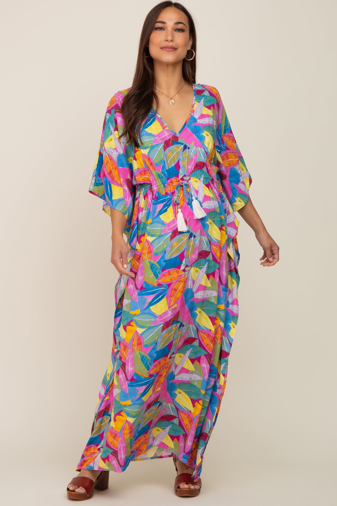 woman wearing a colorful floral maternity dress with a v-neck and drawstring waist