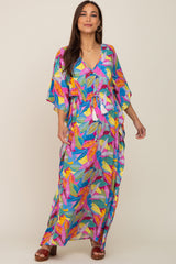 woman wearing a colorful floral maternity dress with a v-neck and drawstring waist