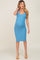 pregnant woman wearing a blue ribbed maternity midi dress and tan heels
