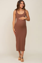 pregnant woman wearing a brown ribbed sleeveless maternity midi dress and tan sandals