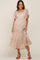 Smiling pregnant woman wearing a floral maternity midi dress with flutter sleeves and tiered skirt