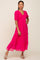 woman wearing a hot pink tiered maxi dress with puff sleeves and smocked bodice