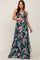 woman wearing a black floral maternity maxi dress and gently holding her baby bump
