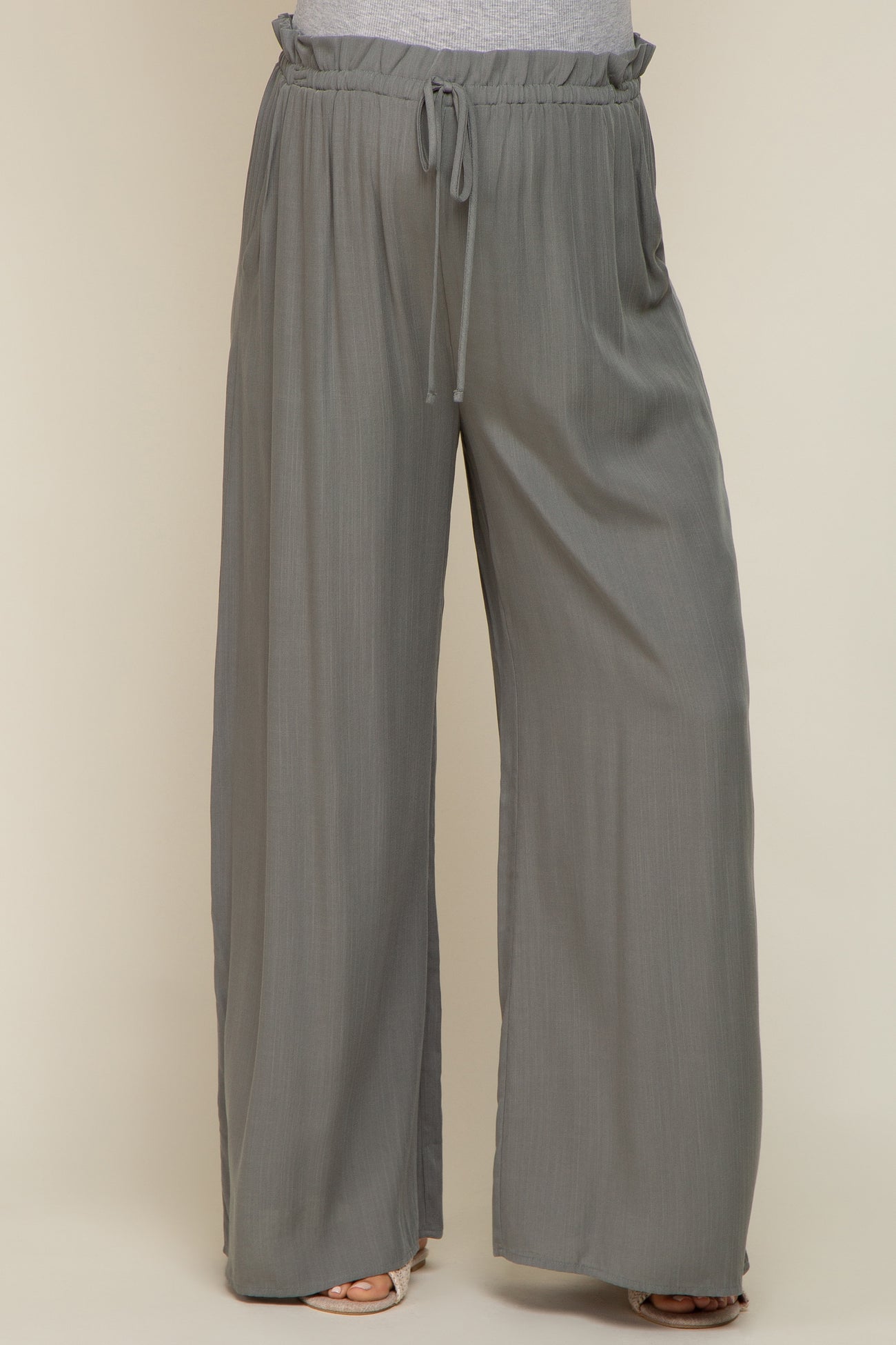 woman wearing grey wide leg pants with drawstring elastic waistband and textured fabric