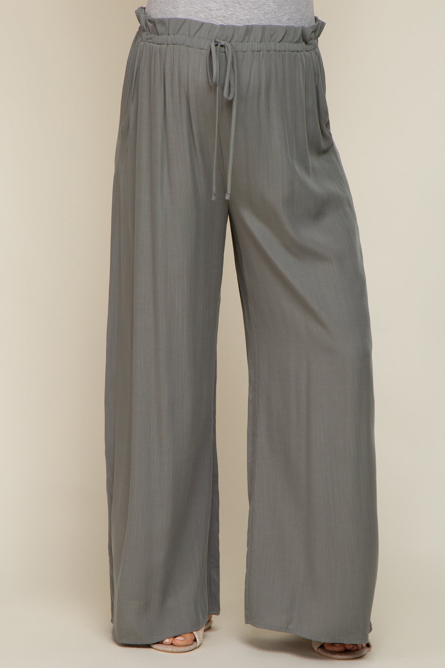 woman wearing grey wide leg pants with drawstring elastic waistband and textured fabric