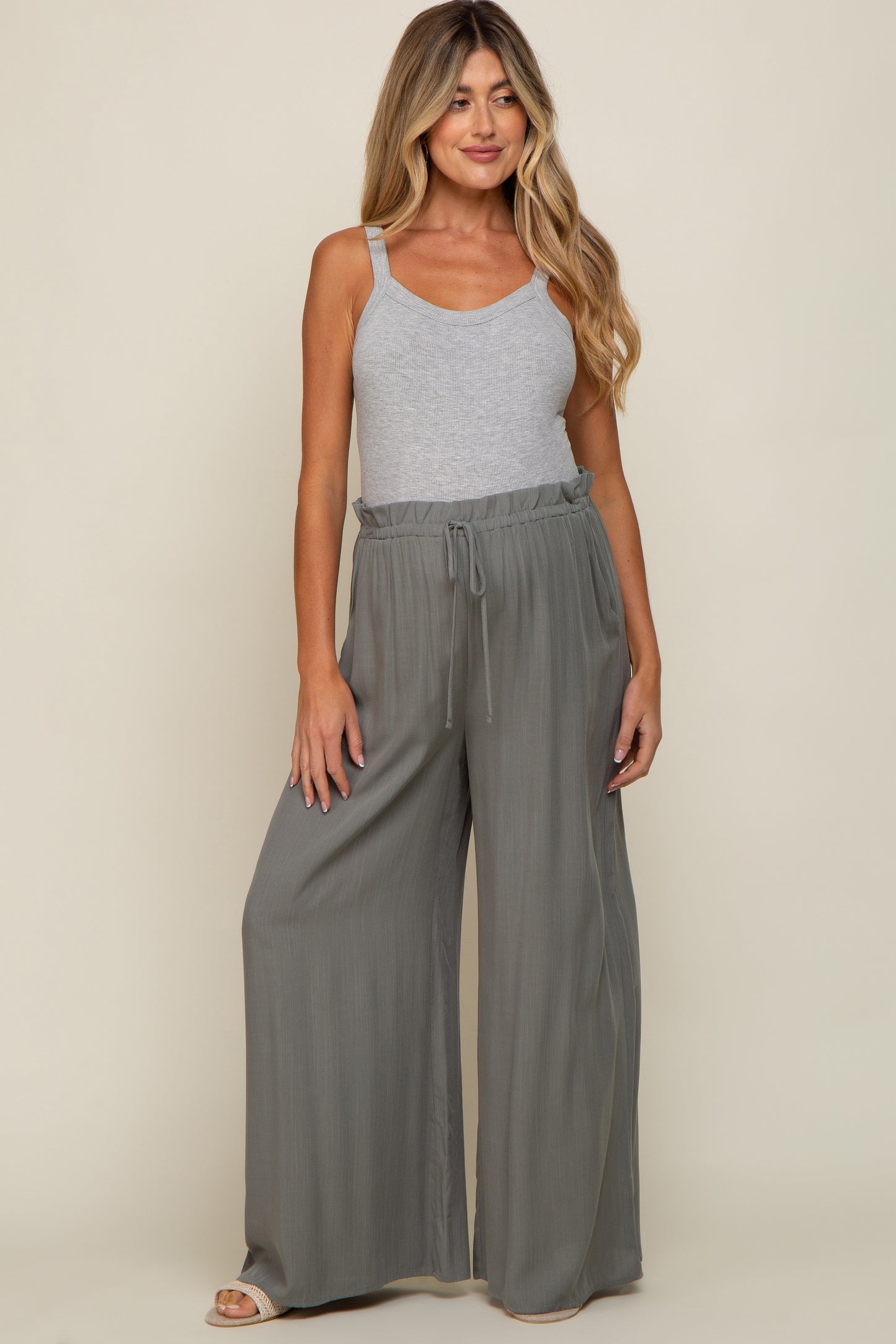 woman wearing a grey ribbed tank top and olive green wide leg drawstring maternity pants