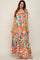 woman wearing a multicolor floral print maternity maxi dress with ruffled tiers and tie straps