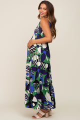 woman wearing a multicolored patterned maternity maxi dress with a visible baby bump