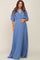pregnant woman wearing a light blue short sleeve maternity maxi dress with a smocked waist