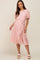woman wearing a light pink short sleeve maternity midi dress with a waist tie and pleated texture