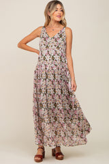 woman wearing a sleeveless floral print tiered maxi dress with brown platform sandals