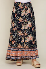 floral print navy blue maxi skirt with button front and smocked waist paired with woven platform sandals