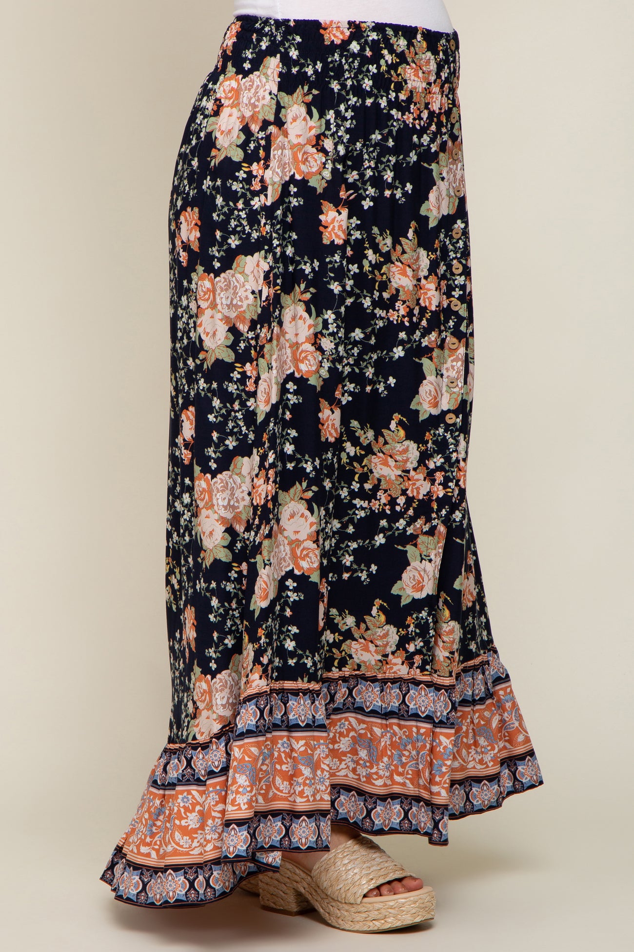 navy blue floral maxi skirt with smocked waist and ruffled hem paired with woven platform sandals