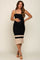 pregnant woman in black ribbed maternity midi dress with tan stripes and spaghetti straps