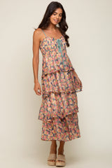 woman wearing a tiered floral midi dress with lace-up bodice and woven platform sandals