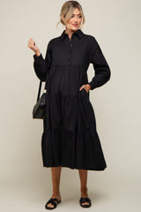 woman wearing a black long sleeve tiered maternity midi shirt dress with a black shoulder bag