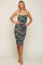 woman wearing a strapless floral bodycon dress with ruching details and a fitted silhouette