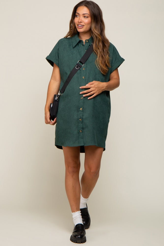 Pregnant woman wearing a green corduroy button-down maternity shirt dress with a black crossbody bag