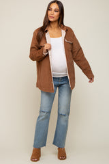 pregnant woman wearing brown corduroy sherpa lined jacket with white maternity top and distressed jeans