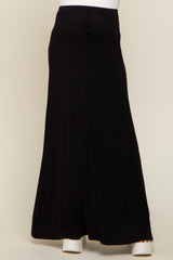 person wearing a long black drawstring maxi skirt with white platform sandals