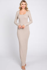 woman wearing a long beige ribbed maxi dress with a square neckline and long sleeves