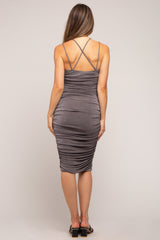 woman wearing a gray maternity dress with spaghetti straps and ruched detailing from the back