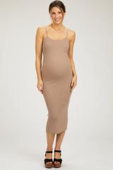 woman wearing a tan ribbed maternity dress with adjustable straps and a visible baby bump