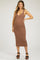 woman wearing a brown maternity dress with a fitted silhouette and spaghetti straps, showcasing her baby bump